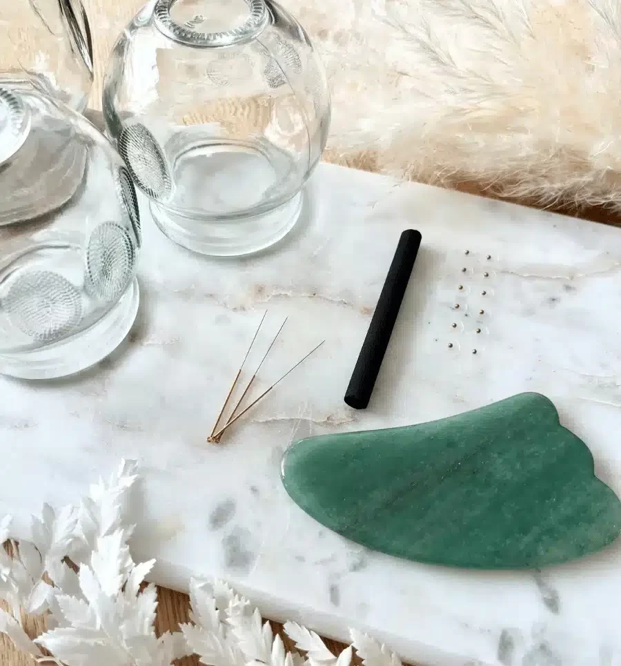 Acupuncture cups, needles and gua sha stone